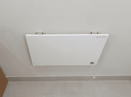 The Folding Wall Table folded flat against a wall
